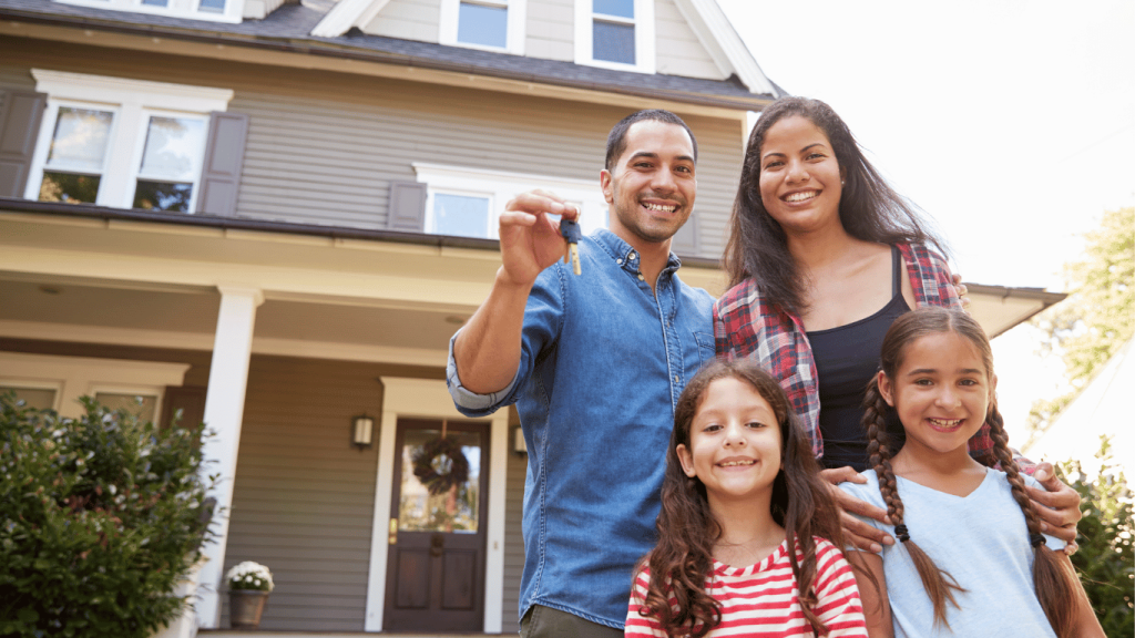 About us is a family of four holding keys to a house that they're standing in front of. That someone just sold them.